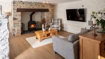 Beautiful sitting-area with glowing wood-burner.