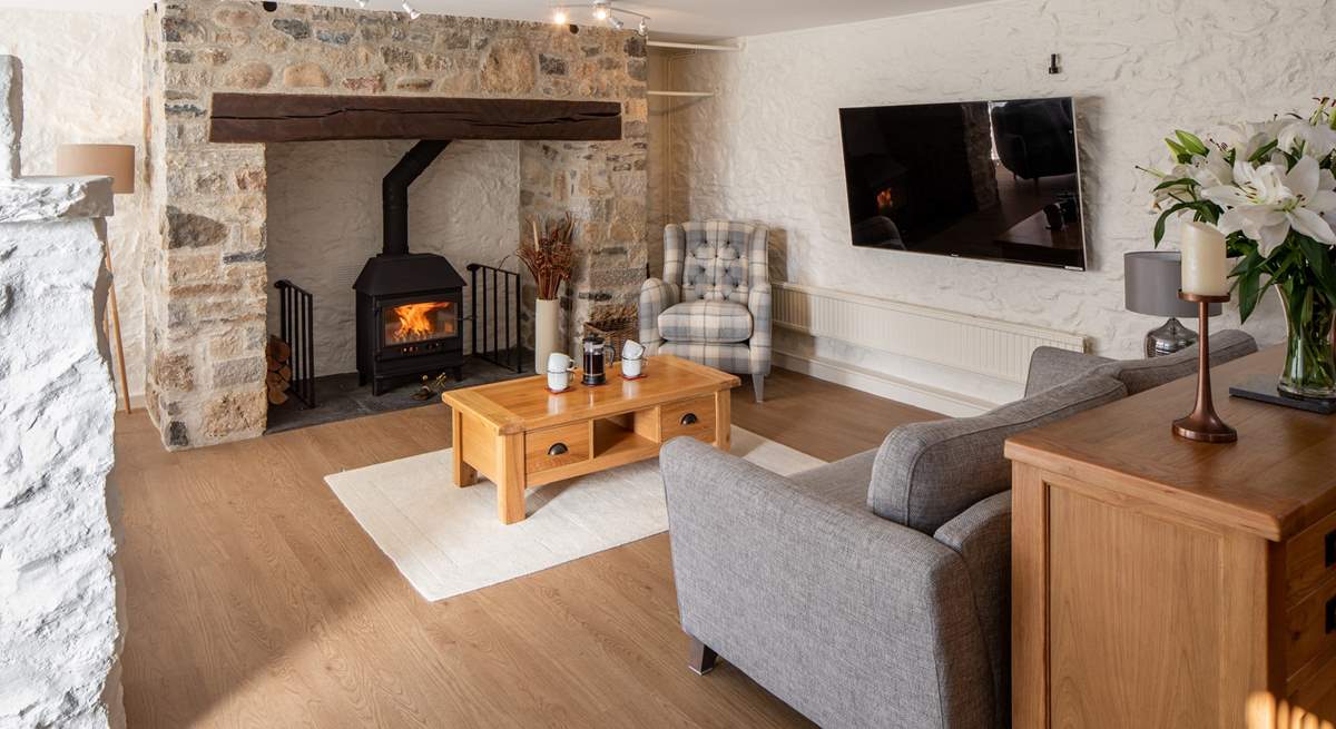 Beautiful sitting-area with glowing wood-burner.