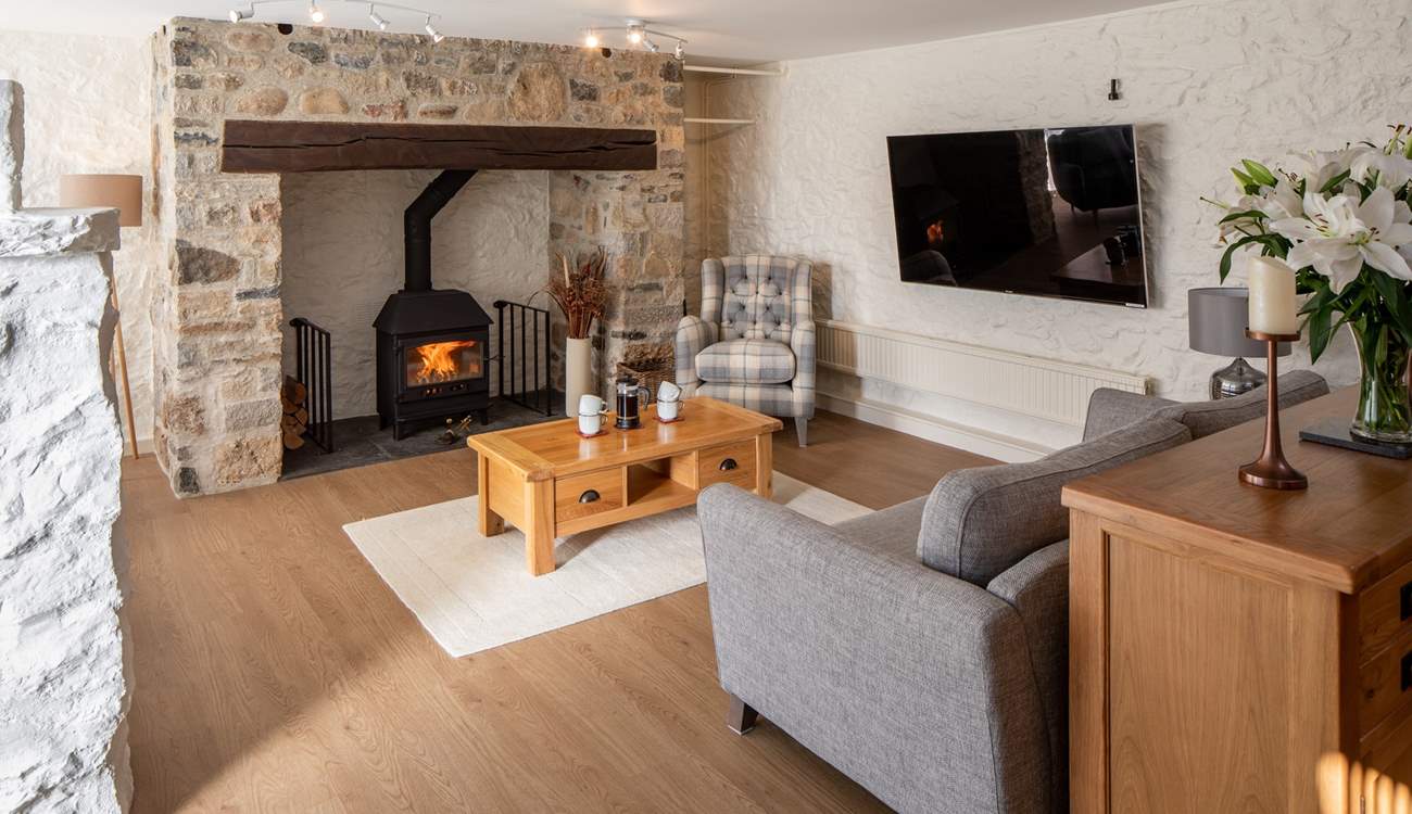 Beautiful sitting-area with glowing wood-burner.