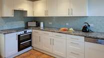 The kitchen is both spacious and fully equipped.