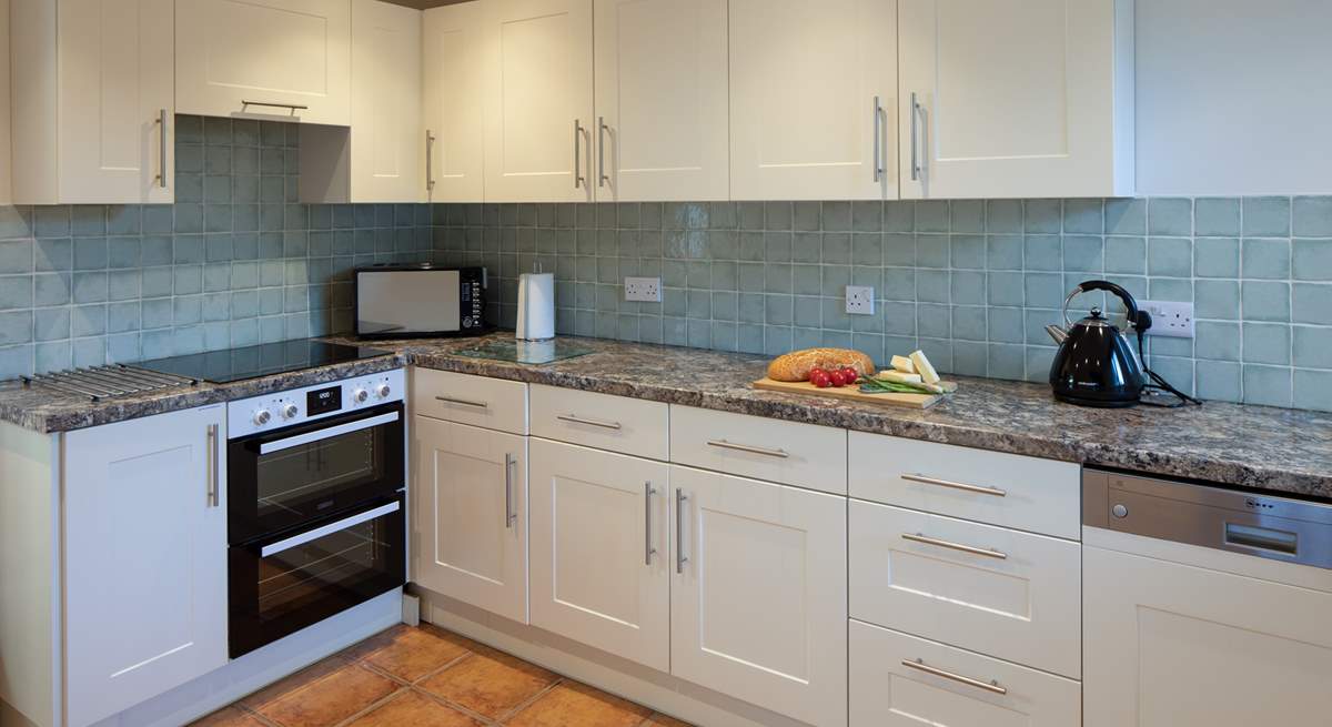 The kitchen is both spacious and fully equipped.