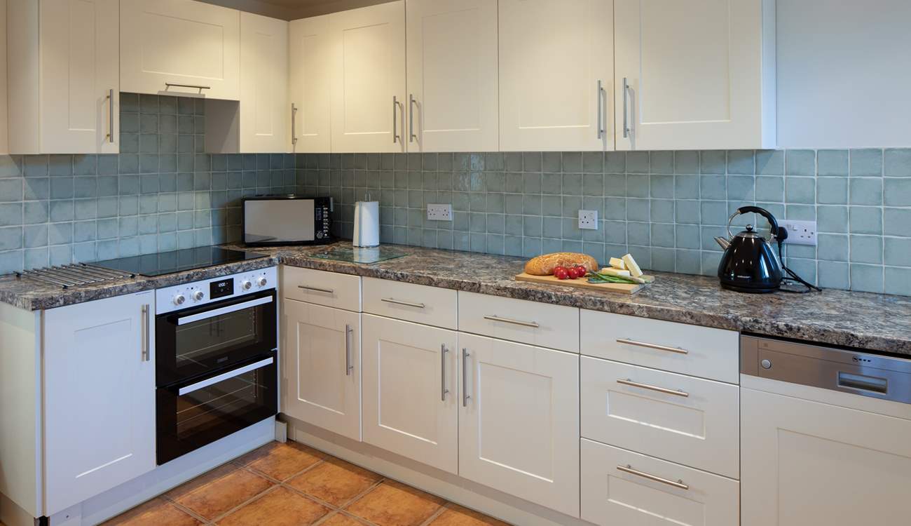 The kitchen is both spacious and fully equipped.