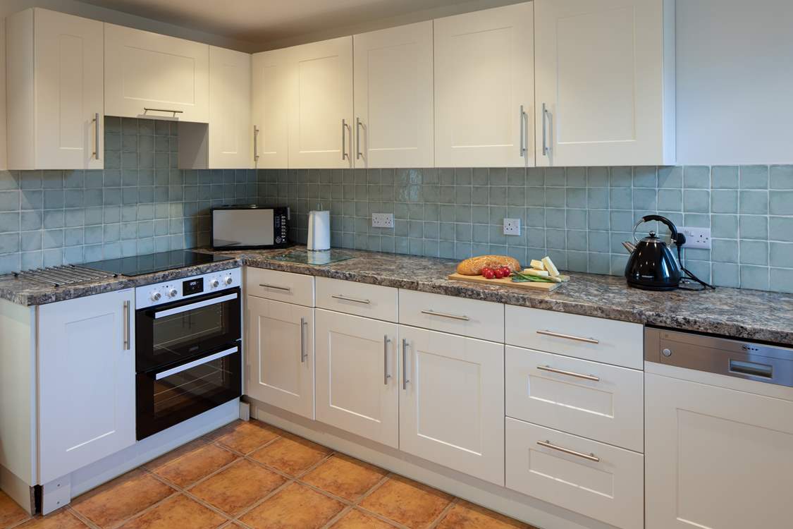 The kitchen is both spacious and fully equipped.