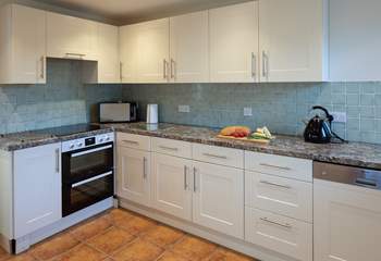 The kitchen is both spacious and fully equipped.