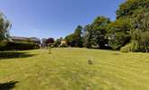 From the bottom of the lawn, looking back at your private raised patio area and hot tub. - Thumbnail Image