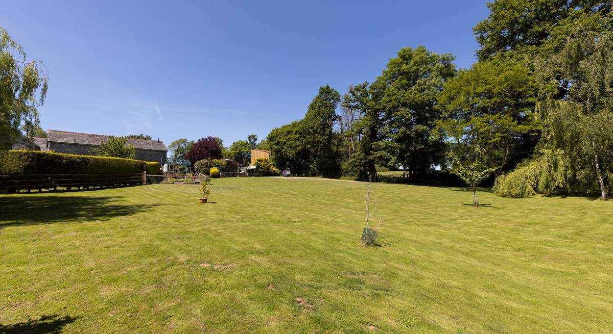 From the bottom of the lawn, looking back at your private raised patio area and hot tub.