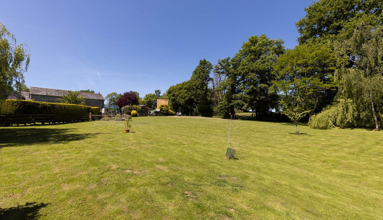 From the bottom of the lawn, looking back at your private raised patio area and hot tub.