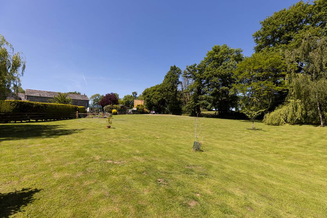 From the bottom of the lawn, looking back at your private raised patio area and hot tub.