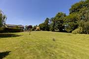 From the bottom of the lawn, looking back at your private raised patio area and hot tub.