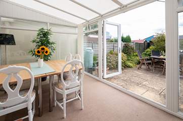 Step out of the super warm conservatory onto the patio.