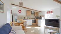 The open plan living room with kitchen and dining areas.