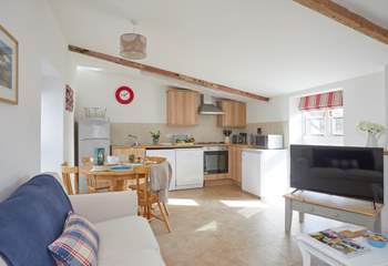 The open plan living room with kitchen and dining areas.