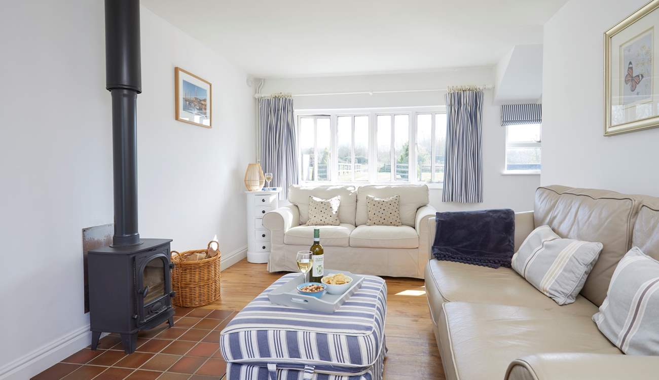 With large windows and a door leading to the garden, this is a lovely spot to relax and enjoy the sunshine.