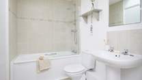 The family bathroom with bath and fitted shower.
