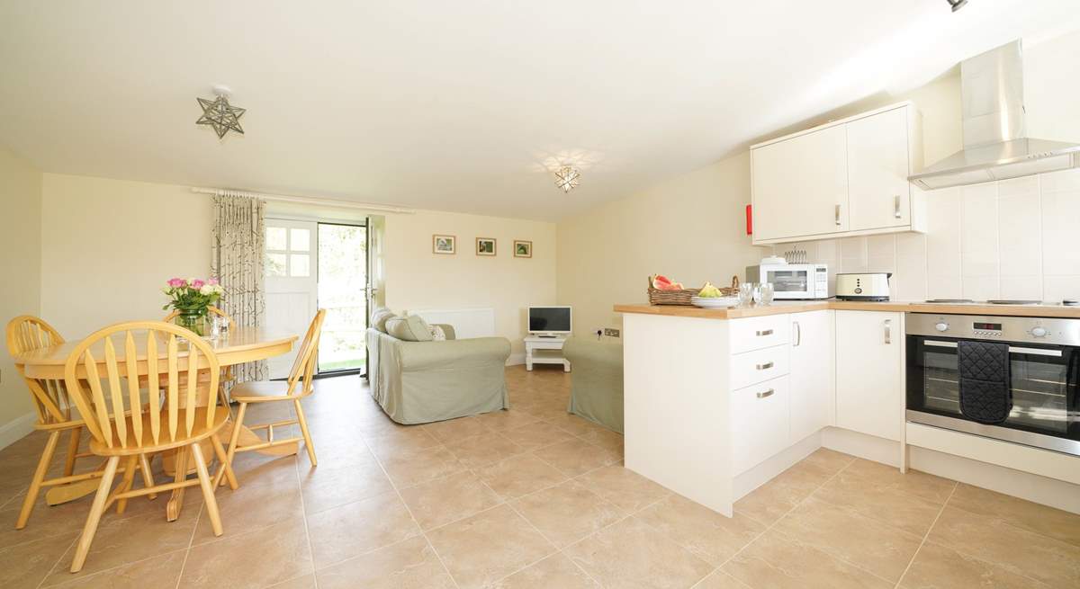 The spacious open plan living-room with kitchen and dining areas. 