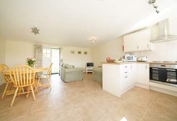 The spacious open plan living-room with kitchen and dining areas. 