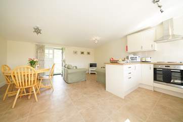 The spacious open plan living-room with kitchen and dining areas.