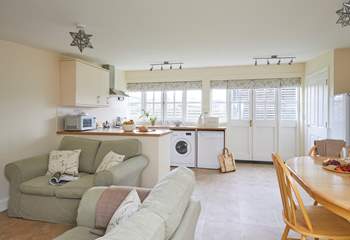 The spacious open plan living-room with kitchen and dining areas. 