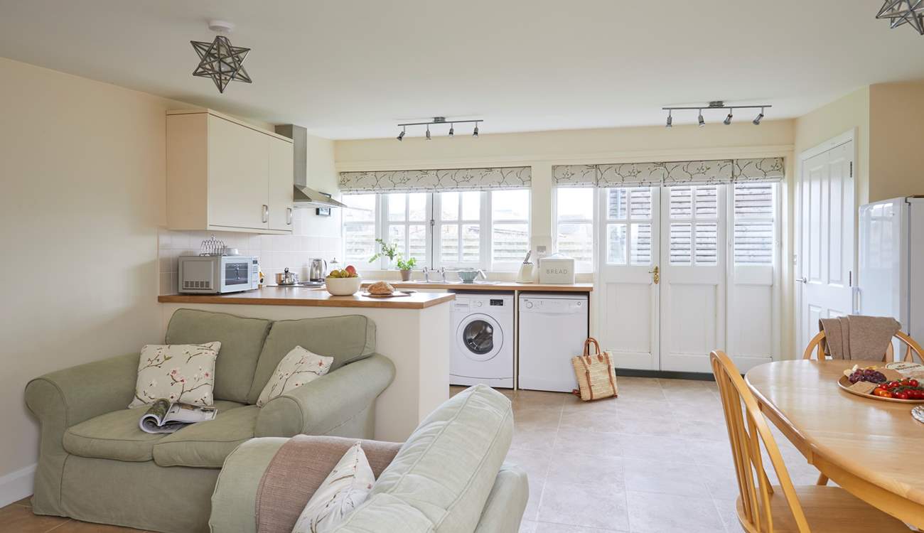 The spacious open plan living-room with kitchen and dining areas. 