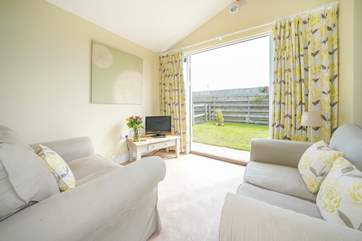The open plan living-room with kitchen and dining area leads out onto the garden.