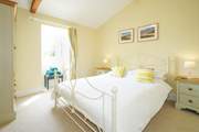 The spacious double bedroom overlooks the front garden area.