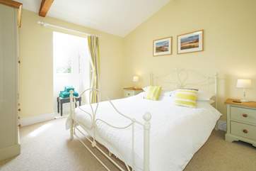 The spacious double bedroom overlooks the front garden area.
