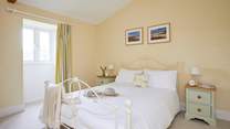 The spacious double bedroom overlooks the front garden area.