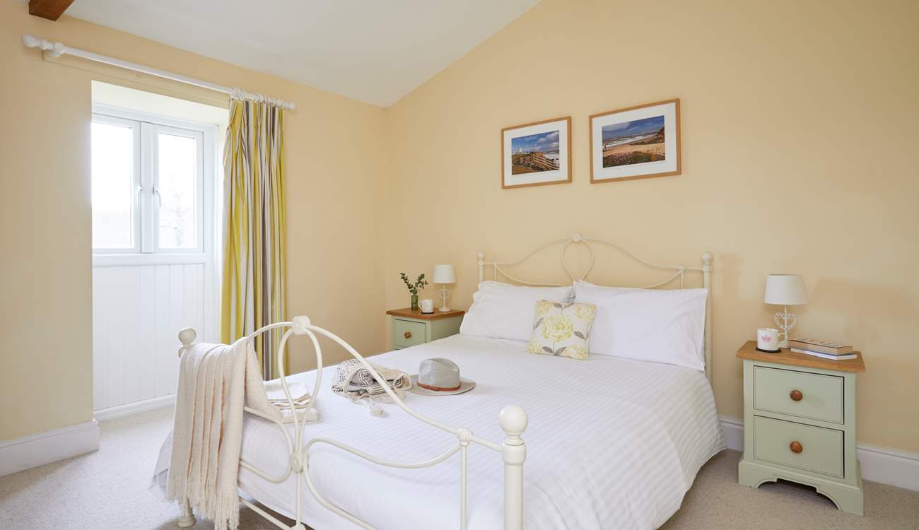 The spacious double bedroom overlooks the front garden area.