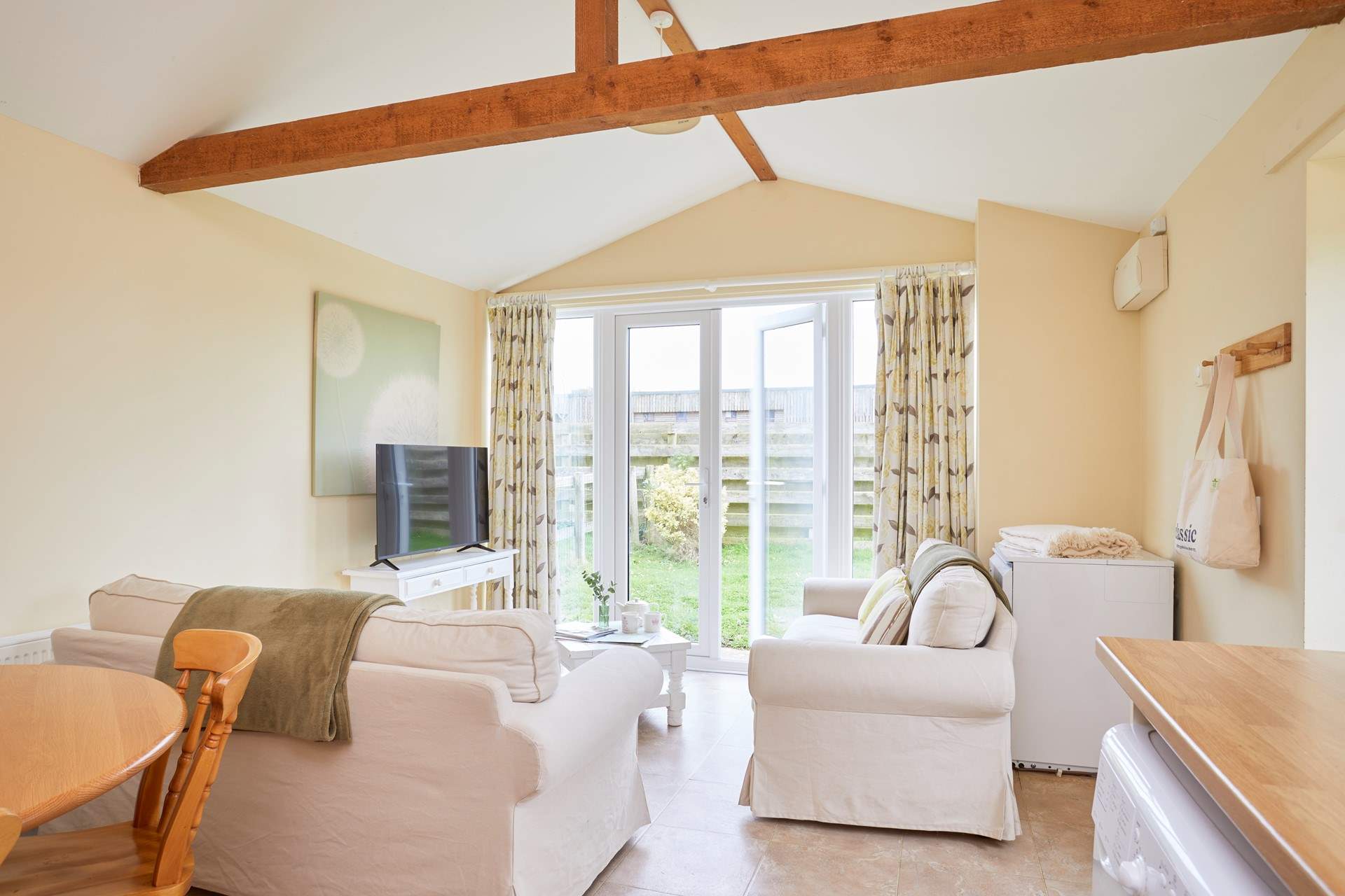The open plan living-room with kitchen and dining area leads out onto the garden. 
