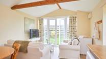 The open plan living-room with kitchen and dining area leads out onto the garden. 