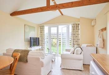 The open plan living-room with kitchen and dining area leads out onto the garden. 