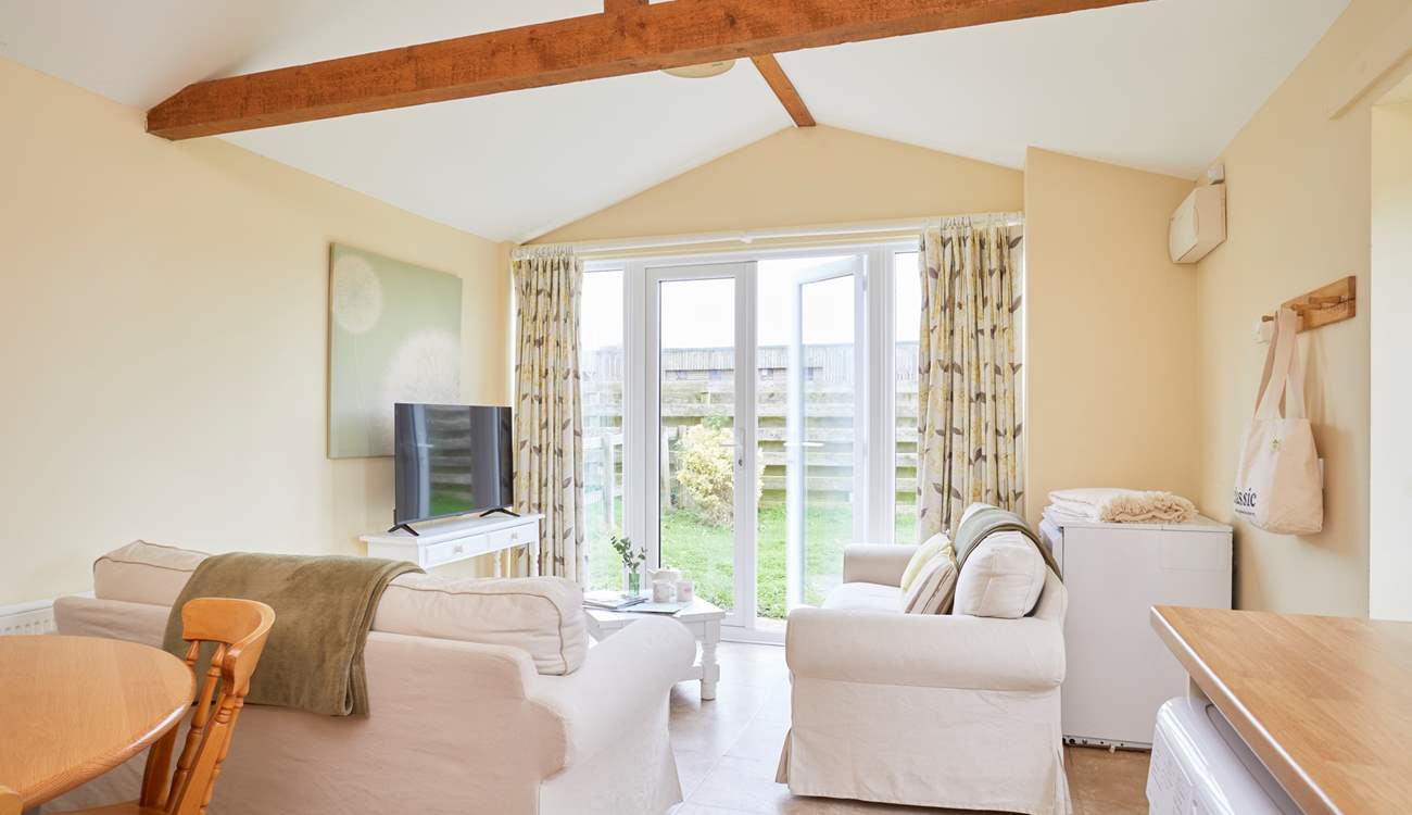 The open plan living-room with kitchen and dining area leads out onto the garden. 