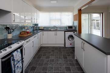 The kitchen is spacious and fully equipped.