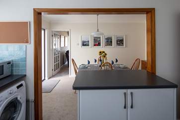 Looking through from the kitchen into the dining area, and into the sitting-room beyond.