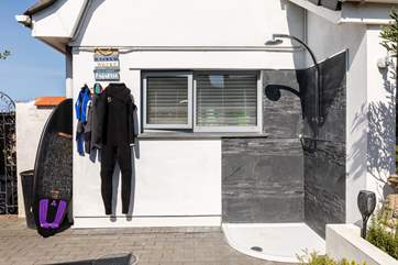 There's plenty of space for your wet suits and surf boards. Wash away the sand in this handy hot water outside shower.