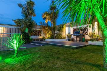 Beautiful lighting enhances the decked area at night.