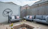 The perfect relaxation corner, with the comfort of sofas and the warmth from the fire-pit, providing the ideal spot for a chilly evening.  - Thumbnail Image