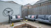 The perfect relaxation corner, with the comfort of sofas and the warmth from the fire-pit, providing the ideal spot for a chilly evening. 