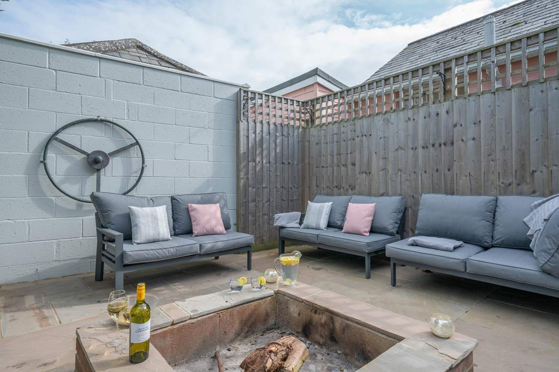 The perfect relaxation corner, with the comfort of sofas and the warmth from the fire-pit, providing the ideal spot for a chilly evening.