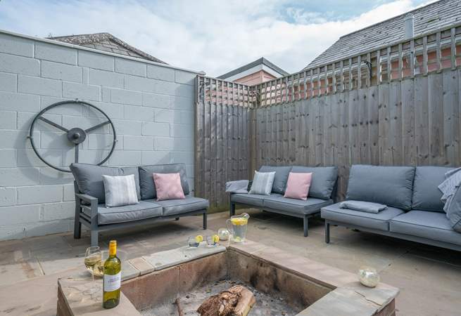 The perfect relaxation corner, with the comfort of sofas and the warmth from the fire-pit, providing the ideal spot for a chilly evening. 