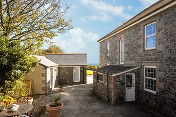 Glimpses of the sea can be seen from the raised sheltered terrace behind the house.
