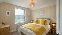 Mellow yellow in Bedroom 1 with double bed.