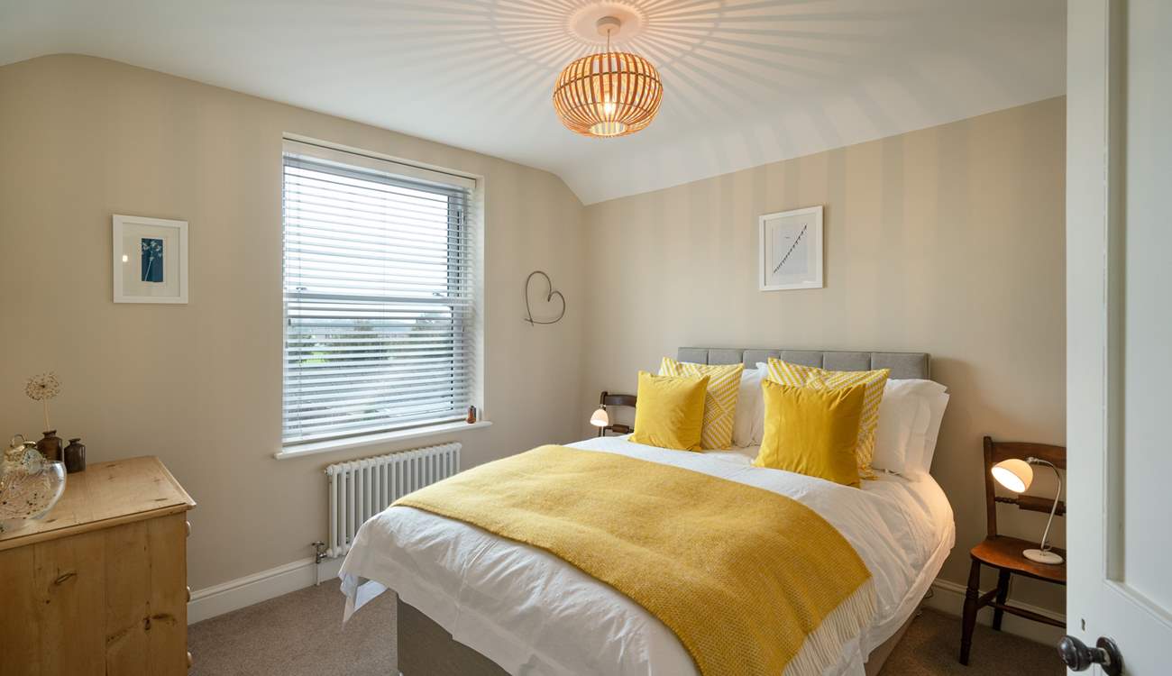 Mellow yellow in Bedroom 1 with double bed.