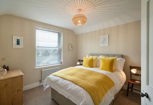 Mellow yellow in Bedroom 1 with double bed.