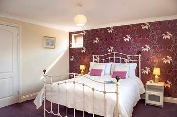 Pretty bedroom 2 has a king-size bed.