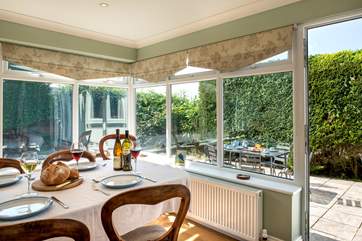 From the dining-room you can step out to the terrace and garden.