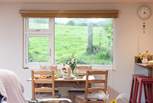 The dining-table looks out across the field, sometime the odd cow or sheep might make an appearance.