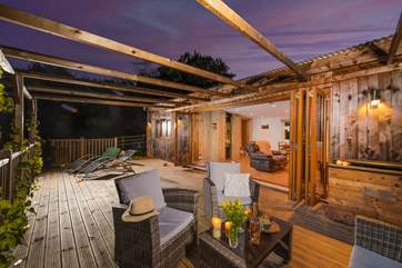 The huge bi-fold doors open up to the large decking area.