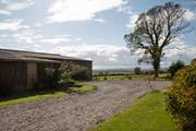 The parking area outside Moorhen Cottage which is also next door to the farm buildings.