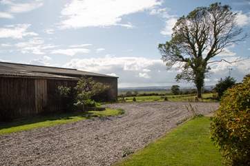 The parking area outside Moorhen Cottage which is also next door to the farm buildings.